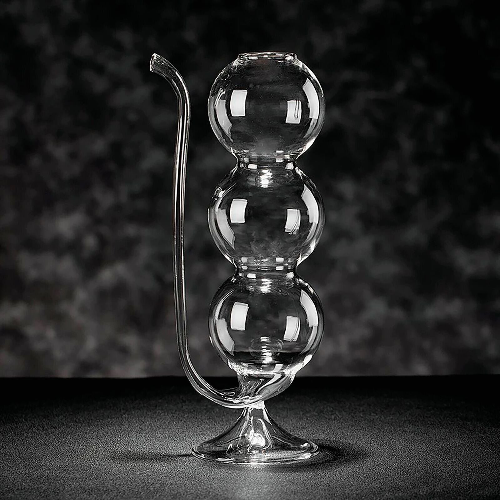 Cocktail glass with spherical shape and straw image number null