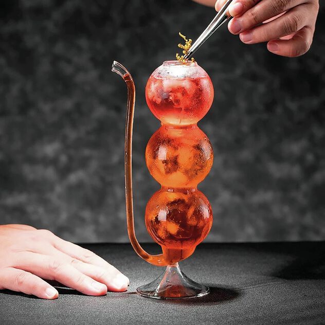 Cocktail glass with spherical shape and straw image number 2